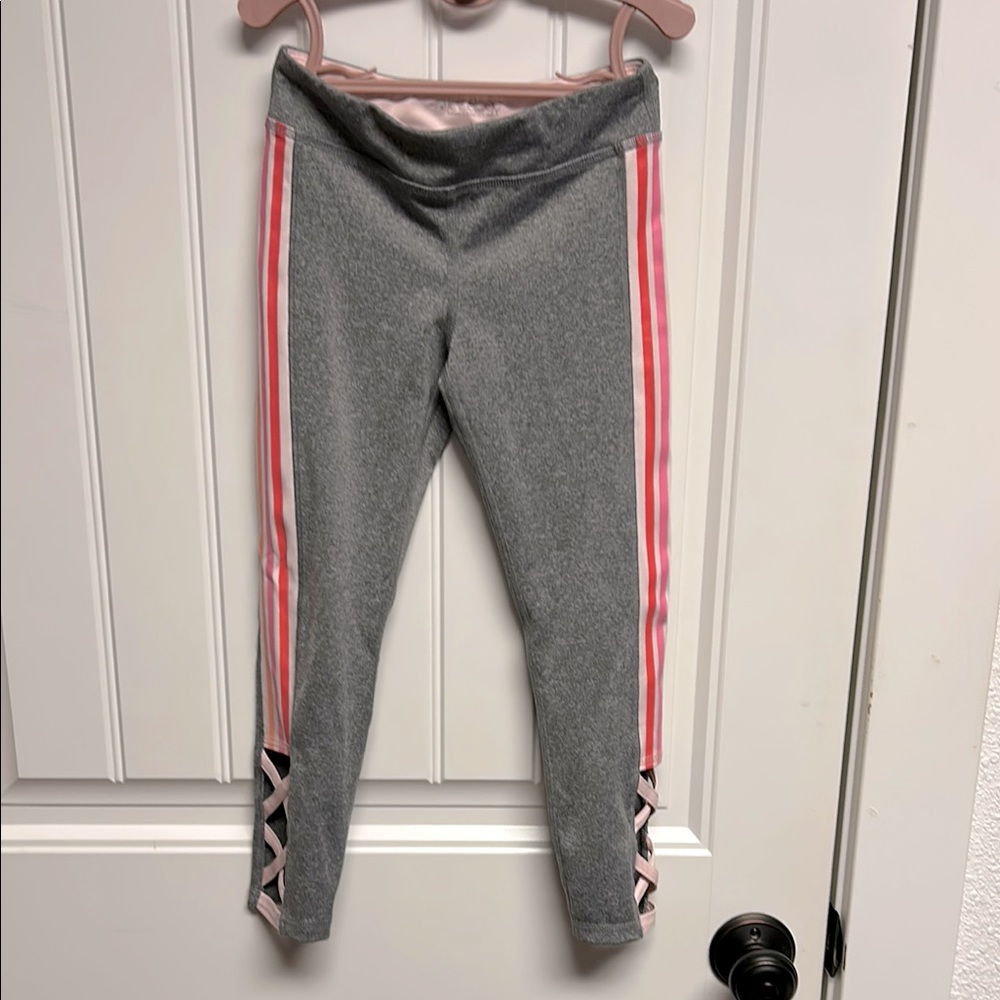 Ideology leggings. Gray with pink/orange stripes and criss cross cut outs Size 5